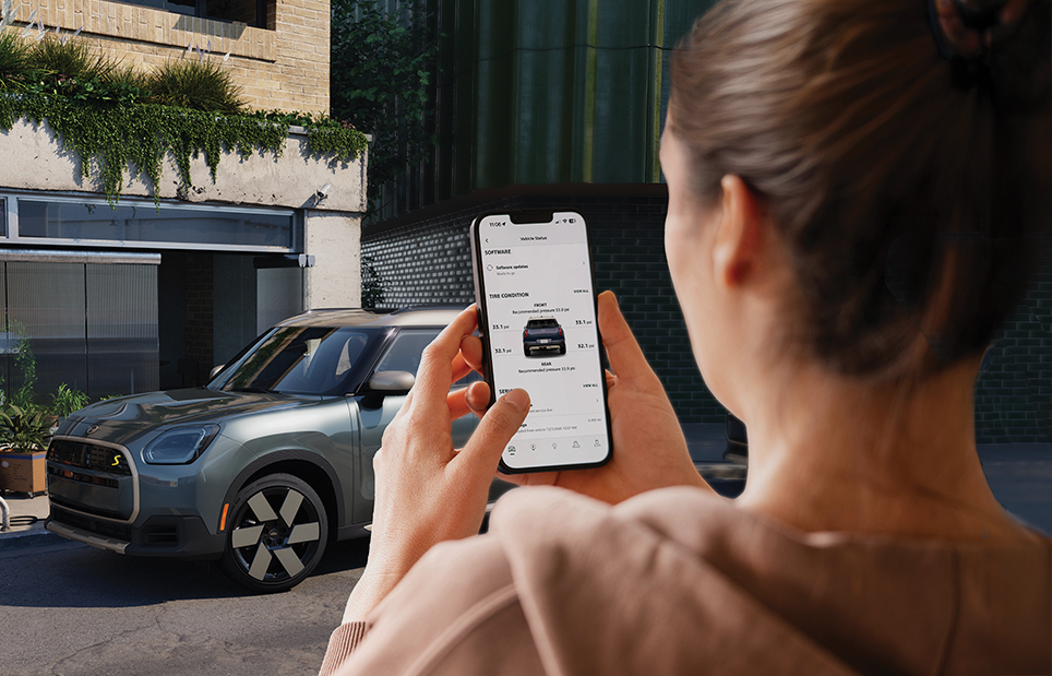 Woman holding a phone showing the digital tire diagnosis app.